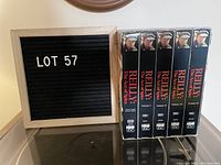 Photo showing the 4 VHS tapes and a letter board with lot number 57