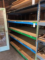 Full view of shelving unit showing 5 shelves and metal frame with wooden inserts.