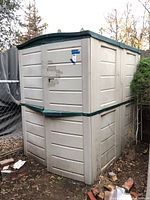 Exterior front-left view showing beige plastic panels and green roof