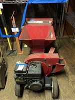 Front view of entire shredder unit showing hopper, engine, wheels and frame