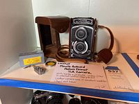 Full lot overview showing camera, case, filter, self timer, and seller note