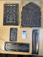 Group view of all five hand-carved wooden ornament molds laid out on table