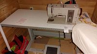 Sewing machine installed on table, showing overall setup