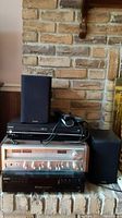 Stacked electronics on hearth: DVD player, VCR, receiver, CD changer and speaker