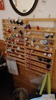 Wood wall hanger loaded with multiple spools of thread in different colors