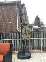 Full view of assembled umbrella and base on deck