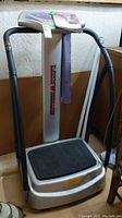 Full view of T-Zone VT-12 vibration machine showing platform, handles and control panel.
