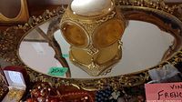 Oval vanity tray with mirrored base and jewelry box on top