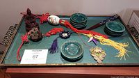 Full lot on green moire glaze tray showing all items: tray, dishes, chopsticks, tassels, statuette, carved objects