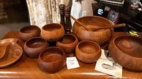 Wide view of the teak wood bowls, shakers, and tray arranged on a table showing all included items and their size proportions.