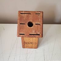 Top view showing the slots and central circular hole for knife storage, with Cutco branding visible.