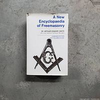 Book cover showing title, author, and Freemasonry symbol on white dust jacket with minor wear and tear.
