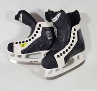 Pair of black and white Graf Supra 370 Pro 2000 youth ice hockey skates, size 4, showing overall design and condition of boots and blades.