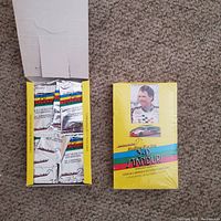 Photo showing two yellow boxes of vintage NASCAR 3D Standups trading cards on a carpet floor. One box is sealed and the other is open revealing sealed packs.