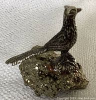 Pewter pheasant mounted on pyrite base, side perspective showing texture and tail detail