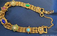 Full view of vintage Goldette bracelet with triple chain design and multicolored stones, safety chain attached.