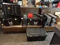 Photo of desktop towers, Sterilite storage cases, and miscellaneous electronics arranged on a bench.