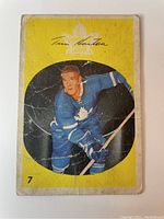 Front of 1962-63 Parkhurst Tim Horton card showing player in Toronto Maple Leafs uniform with creases and edge wear.
