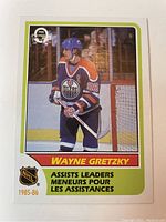 Front of the 1986 O-Pee-Chee Wayne Gretzky assists leader card showing player image, name, team logo, and branding.