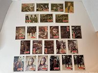 Overview photo showing 24 trading cards arranged in four rows; top two rows have green back cards, bottom rows have white back cards. Cards display scenes and characters from the 1967 movie Planet Of The Apes.