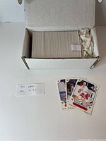 Box containing 341 Ontario Hockey League hockey cards from the 1991-1992 season with a few cards laid out in front showing players in team uniforms.