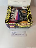 Opened box showing inside with music cards stacked and promotional insert visible
