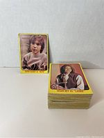 Stack of yellow border Partridge Family cards showing front cards of David Cassidy and Susan Dey