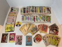 Flat lay of stacks and spreads showing fronts of various 1960s hockey cards, puzzle pieces, and odd shapes.