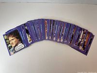 Photo showing a fanned layout of numerous 1978 Mork & Mindy trading cards with a purple border featuring character images.