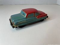 Front and side perspective of the blue and red Plymouth Belvedere tin toy car showing details and color.