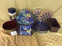 Photo of assorted tin ware and baskets showing decorative tins including pie tins and collector tins alongside decorative baskets.