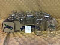 20 quart canning jars, mix of wide mouth and regular mouth, mostly clear glass with silver metal lids. Some jars in original boxes.