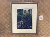 Photo shows original oil painting of floral scene with burgundy and blue flowers, set in traditional frame with white mat border.