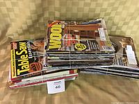Stack of approximately 75 assorted woodworking magazines tied together with string