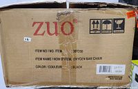 Original cardboard box of Zuo Modern Oxygen Bar Chair showing item details including brand, model number, color, and handling icons.