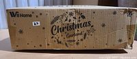 Box of WBHome Christmas Garland with branding and product name visible. The box is labeled with a lot number '27'.