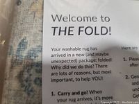 Close up of the rug material and printed welcome note about the washable rug and packaging.