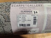 Photo of the rolled-up rug label showing brand, collection, design, size, color, and made in Turkey information.
