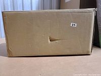 Cardboard box labeled with lot number 39 containing the pendant light.