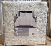 Packaged VCNY Home Caroline quilt set in white with embossed floral design, queen size, new condition.