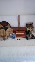 Full lot image showing cedar box, calendar, buttons, crystals, stones, sponges, wooden bowl, glass bird figurine