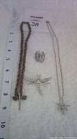 Full set of four dragonfly and butterfly themed silver jewelry items arranged on a light background with white measuring tape for scale.