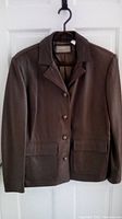 Front view of a brown leather Liz Claiborne jacket with buttons and pockets