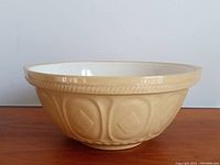 Side view of bowl showing exterior embossed pattern and glaze color.