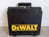Closed black hard plastic carrying case with yellow DeWalt logo on front.