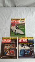 Three vintage Hot Rod magazines laid out on a white background showing front covers. Covers include drag racing car with driver, workshop engine scene, and cartoon car with large rear tires.