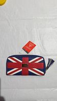 Front view of the wallet displaying the Union Jack flag design with brand tag attached.