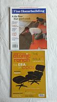 Photo showing both magazines, Fine Homebuilding with tile floor installation cover and Atomic Ranch with yellow cover