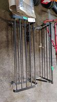 Metal Ikea Portis shoe rack with six horizontal bars, rectangular dark metal frame.