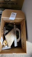 Box containing multiple plaster spreaders for drywall plastering.